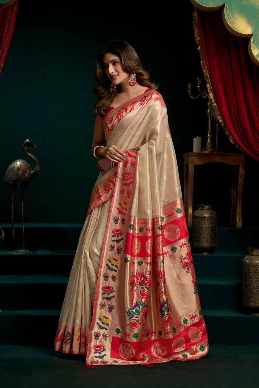 Woman wearing a traditional saree with floral patterns in a dark setting